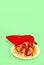 Spaghetti pasta with ketchup and red lady shoes in green background. Minimalism.  Diet, calory Italian food art concept