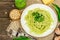 Spaghetti pasta with pesto sauce and fresh ramson leaves. Cutlery, parmesan, pine nuts. Rustic style