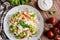 Spaghetti pasta salad with tomato, lettuce, egg, Feta cheese, green onion and sour cream