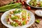 Spaghetti pasta salad with tomato, lettuce, egg, Feta cheese, green onion and sour cream