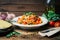 Spaghetti pasta with tomato sauce, parmesan and basil on a white plate. The classic tomato spaghetti: vegetarian tomato basil