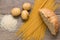 Spaghetti, rice, potatoes, and bread, on a table