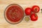 Spaghetti sauce with red vine ripe tomatoes on wood background