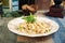 Spaghetti tagliatelle alfredo with chicken and mushroom garnished with basil leave