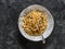 Spaghetti with tomatoes canned tuna sauce on a dark background, top view