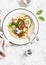 Spaghetti with vegetarian lentil bolognese on a light background.