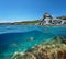 Spain coastline rocky islet and fish underwater