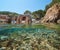 Spain cove with boathouse and fish underwater sea