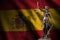 Spain flag with statue of lady justice and judicial scales in dark room. Concept of judgement and punishment