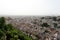 Spain. Granada.View of town with red roofs on white sky background, horizontal view.