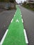 In Spain, a green pedestrian road with a painted figure of a man goes into the distance