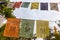 Spain, June 2021: Tibetan mantra flags with Sanskrit texts spreading in the wind, Buddhist decoration in Panillo monastery, Spain