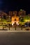 Spain, Malaga,  MÃ¡laga PEOPLE STANDING ON ILLUMINATED STREET AGAINST BUILDINGS IN CITY AT NIGHT