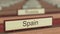 Spain name sign among different countries plaques at international organization. 3D rendering