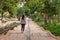 Spain; Nov 2020: Person walking at Arab gardens inside an old fortification, traditional Islamic gardens with walkways and flowing