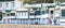 Spain, Oct 2021: Traditional wooden houses by the beach, green and white cabins, Garraf between Barcelona and Sitges, Spain