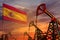 Spain oil industry concept. Industrial illustration - Spain flag and oil wells with the red and blue sunset or sunrise sky