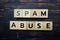 Spam Abuse alphabet letter on wooden background