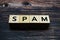 Spam alphabet letter on wooden background