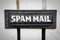 Spam Mail concept. Metal mailbox in a white wooden fence