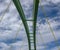 Span of an arched bridge against a blue sky with clouds