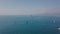 The span of the drone over the sea near the coast of Italy. Boats and ship on the water. Mediterranean Sea. Aerial view
