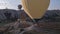 The span of a large yellow balloon, in a basket of people, close-up. Flying over the mountains - Panorama of Cappadocia