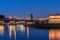 The span of the Trinity bridge, raised up, rises above other historical buildings of the city