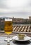 Spanish beer and glass bowl with green andalusian olives served on outdoor terrace with view on Sierra Nevada mountains in Granada