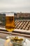 Spanish beer and glass bowl with green andalusian olives served on outdoor terrace with view on Sierra Nevada mountains in Granada