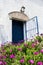 Spanish blue old entrance door with the open gate in white house