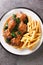 Spanish Bull Tail Stew Rabo De Toro served with french fry closeup in the plate. Vertical top view