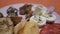 Spanish Chef snackes rotating food plate with york ham, potato chips, egg with black salt, salami chorizo,marmalade