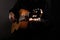 Spanish classical guitar and guitarist`s hands up close on a black background with copy space