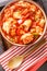 Spanish dish cod ajoarriero prepared on a sauce made from tomato sauce, onion, piquillo peppers, bell peppers closeup on the bowl