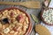 Spanish fabada in an earthenware dish and a wooden fork and knife