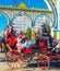 Spanish families in traditional and colorful dress travelling in a horse drawn carriages at the April Fair, Seville Fair