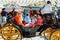 Spanish families in traditional dress travelling in a horse drawn carriages at the April Fair, Seville Fair