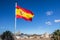 Spanish flag flies over Seville skyline including Cathedral