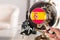 Spanish flag on globe through magnifying