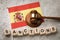 Spanish flag, judge gavel and wooden cubes with text, concept on the theme of sanctions from Spain