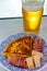 Spanish food and drink, glass of fresh beer and portion of  potato omelette tortilla de patatas with onion served with cheese and