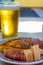 Spanish food and drink, glass of fresh beer and portion of  potato omelette tortilla de patatas with onion served with cheese and