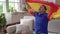 A Spanish football fan watches TV at home with the flag of Spain. Emotional Spanish male sports fan