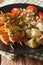 Spanish kebab Pinchos Morunos and potato with tuna and herbs closeup. Vertical