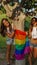 Spanish lesbian couple posing with a pride flag