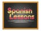 Spanish lessons chalk lettering on black chalkboard. Flag of Spain