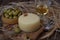 Spanish Manchego cheese with white wine, nuts and olives on wooden background