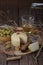 Spanish Manchego cheese with white wine, nuts and olives on wooden background