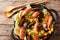 Spanish paella with shrimps, mussels, fish, and baby octopus close-up in a frying pan. horizontal top view